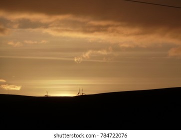 Distant windmills at sunset