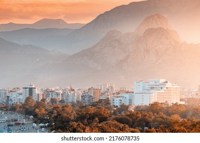 Distant zoom cityscape view of Antalya resort town with hotels and buildings and Taurus mountains in the background - Shutterstock ID 2176078735