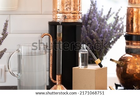 Distillation of lavender essential oil. Copper alambic in a Scandinavian interior. Chemical laboratory