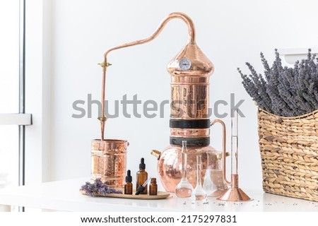 Distillation of lavender essential oil. Copper alambic in a Scandinavian interior. Chemical laboratory