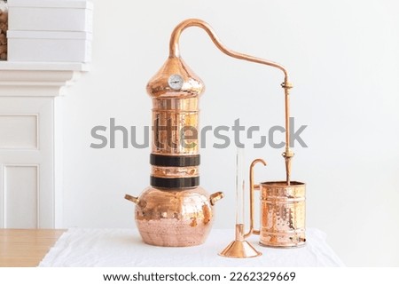 Distillation of lavender essential oil. Copper alambic in a Scandinavian interior.