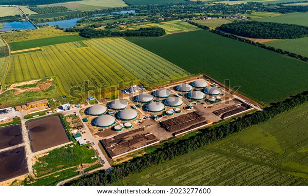 Distillation process is used to produce bio gas\
at station. Biogas station at the green field. View from above.\
Ecological production\
concept