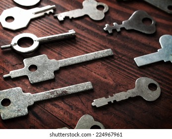 Distinctive Keys. Many Odd Shaped Keys On Old Wood Table . Security And Encryption, Concept Image. 