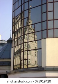 Distorted reflection of historical building in mirror surface of modern building. Fragment of city architecture, Moscow city.