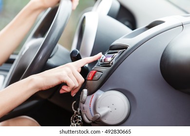 Distracted Driver. Attractive Blonde Woman Changing Radio Station In Her Car