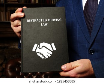  DISTRACTED DRIVING LAW Book In The Hands Of A Lawyer. Distracted DrivingÂ occurs When A Driver Undertakes Any Activity That Diverts Attention Away From Driving
