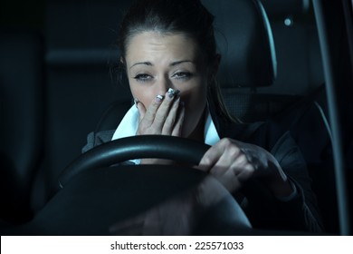 Distracted Exhausted Woman Driving A Car Late At Night.