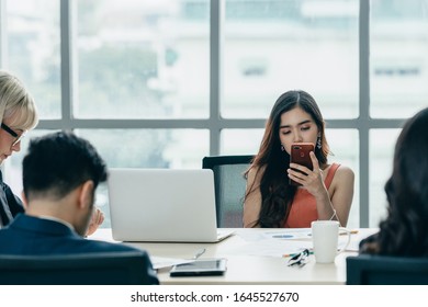 Distracted Girl Use The Phone While Meeting