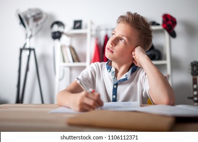 Distracted Preteen Boy Trying To Doing Homework And Thinking About Something