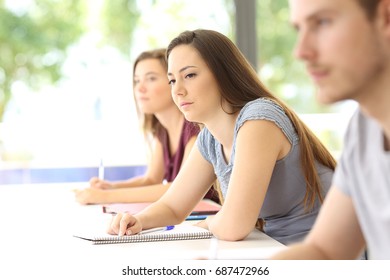 Distracted Student Looking Away During A Class In A Classroom