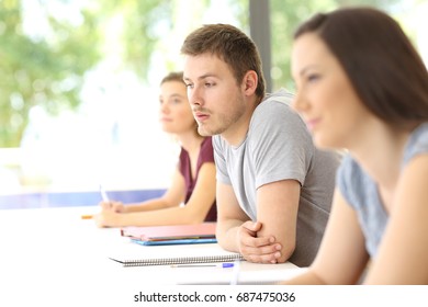 Distracted Student Looking Away During A Class At Classroom