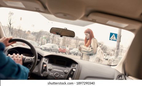 Distracted Teenage Girl Texting, Using Her Mobile Phone While Crossing The Street. Male Driver Honking The Horn In The Car. Technology And Transportation Concept. Selective Focus On A Pedestrian