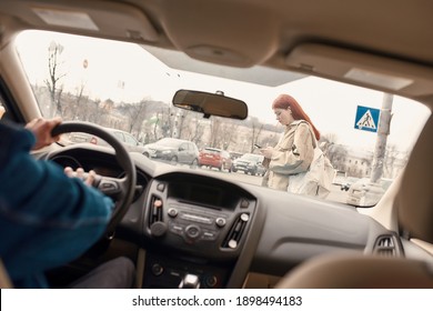 Distracted Teenage Girl Texting, Using Her Mobile Phone While Crossing The Street. Male Driver Honking The Horn In The Car. Technology And Transportation Concept. Selective Focus On A Pedestrian