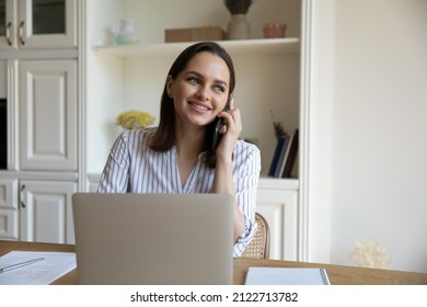 Distracted From Working On Laptop Happy Young Businesswoman Listening Pleasant News Enjoying Cellphone Call Conversation, Discussing Online Project Success With Colleagues, Multitasking In Office.