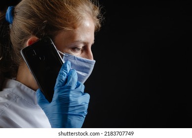 A Distraught And Depressed Female Doctor Speaks To A Patient Over The Phone. A Doctor Talks On The Phone About A Bad Diagnosis. A Female Doctor Or Nurse Is On The Phone Saying Bad News, Test Results