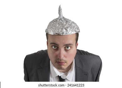distraught looking conspiracy believer in suit with aluminum foil head isolated on white background