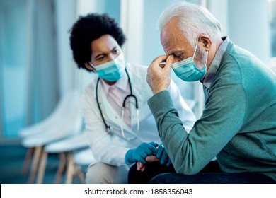 Distraught Senior Man Holding His Head In Pain After Getting Bad News From A Doctor At The Hospital During COVID-19 Pandemic. 