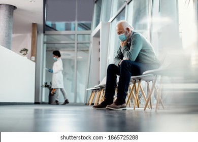 Distraught senior man wearing face mask while sitting alone in hallway at he hospital. Copy space.  - Powered by Shutterstock