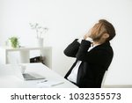 Distraught stressed businessman in suit covers face with hands feeling despair after business failure online sitting at work desk with laptop, frustrated hopeless entrepreneur shocked by bankruptcy