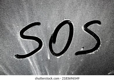 Distress Signal, SOS, On A Black Blackboard .