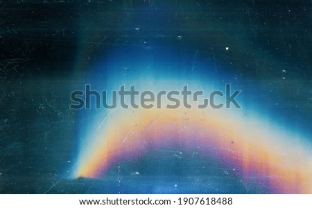 Distressed background. Colorful lens flare. Blue weathered faded stained glass with dust scratches texture smeared dirt blur rainbow light effect.