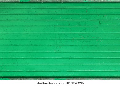 Distressed Green Metal Textured. Cargo Bed Of A Miniature Toy Pickup Truck. Rough Grunge Texture With Peeled Of Paint And Scratches.