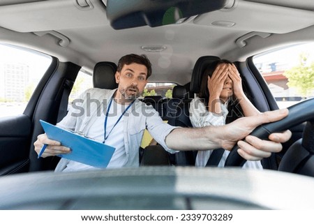 Distressed millennial man auto instructor takes exam in young woman. Avoiding car crash. Scared young woman cover her face with hands. Instructor drives car in stressful situation