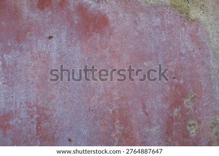 Distressed red wall featuring a background texture with aged paint and deterioration