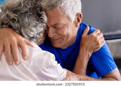 Distressed senior caucasian couple embracing and crying in group therapy session. Senior lifestyle, friendship and support, retirement, unaltered. - Powered by Shutterstock