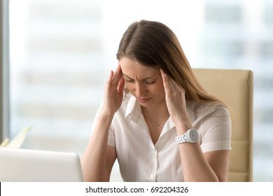 Distressed Unhappy Businesswoman Suffering From Strong Headache, Massaging Temples, Depressed Woman Experiencing Panic Attack Trying To Calm Down, Stress, Anxiety And Depression Concept, Portrait