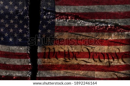 Distressed US flag split in two with We The People constitution text-- American political division concept                               