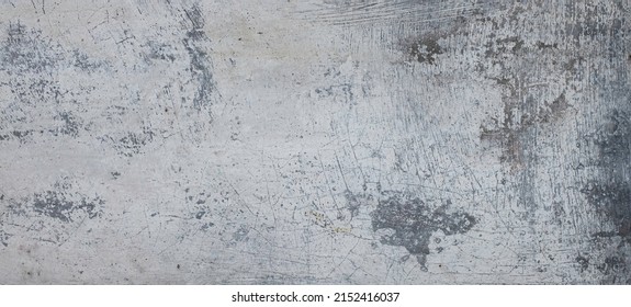 Distressed weathered gray and white cement wall with cracks and crevices in Bali, Indonesia