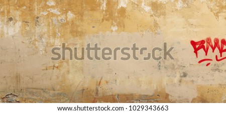 Distressed Yellow Brown Old Brick Wall With Graffiti Street Art. Background And Painted Lines And Draw. Abstract Grunge Modern Grafitty Wallpaper. Abstract Plastered Wall Web Banner. Design Element.