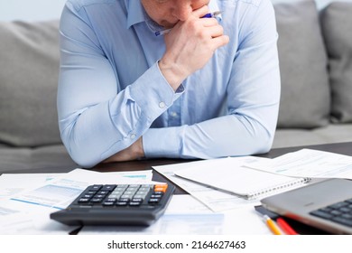 Distressed young man sit at desk paying bills feel stressed having financial problems. Unhappy upset male frustrated by debt or bankruptcy managing household budget or expenses. - Shutterstock ID 2164627463