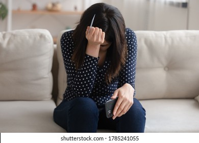 Distressed Young Woman Hold Cellphone And Credit Card Frustrated By Internet Shopping Failure Or Mistake. Unhappy Girl Have Problem With Online Banking Service System, Cyber Fraud. Scam Concept