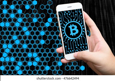 Distributed ledger technology , Man holding mobile phone, block chain text and blockchain icons with binary coded background , cryptocurrencies or bitcoin concept