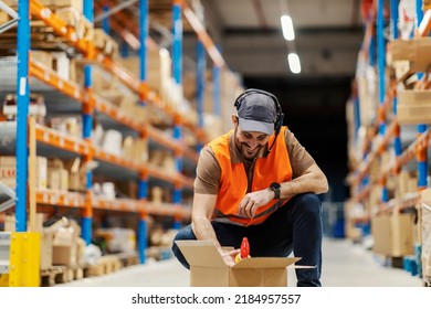 A Distribution Center Worker Putting Goods In Delivery Box.