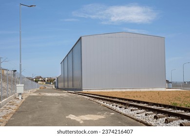 Distribution Warehouse Building Exterior With Rail Road Tracks - Powered by Shutterstock