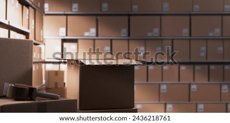 Distribution warehouse interior with many cardboard boxes on shelves