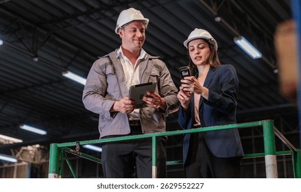 Distribution warehouse manager and client businesswoman using digital tablet checking inventory storage on shelf. Storehouse business worker and logistic engineer standing together at storage service