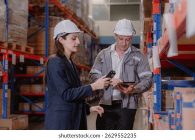 Distribution warehouse manager and client businesswoman using digital tablet checking inventory storage on shelf. Storehouse business worker and logistic engineer standing together at storage service