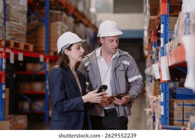 Distribution warehouse manager and client businesswoman using digital tablet checking inventory storage on shelf. Storehouse business worker and logistic engineer standing together at storage service