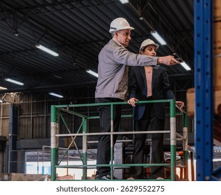 Distribution warehouse manager and client businesswoman using digital tablet checking inventory storage on shelf. Storehouse business worker and logistic engineer standing together at storage service