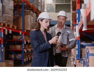 Distribution warehouse manager and client businesswoman using digital tablet checking inventory storage on shelf. Storehouse business worker and logistic engineer standing together at storage service