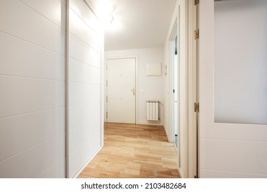 Distributor corridor with white walls, wardrobe with sliding doors and white lacquered wood carpentry
