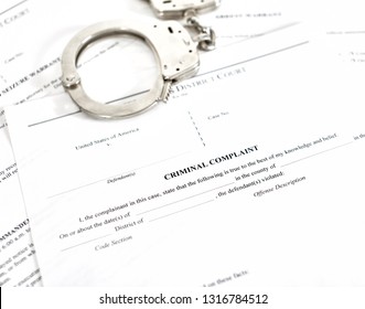 District Court Criminal Complaint, Arrest Warrant And Search And Seizure Warrant Doccuments With Handcuffs Isolated On White