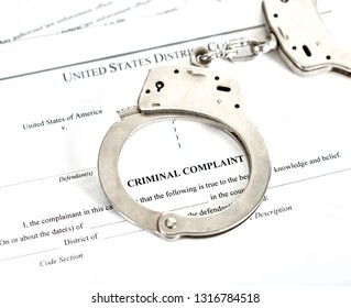 District Court Criminal Complaint, Arrest Warrant And Search And Seizure Warrant Doccuments With Handcuffs Isolated On White