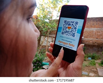 District Katni, Madhya Pradesh, India - April 27, 2020: An Asian Girl Touching Aarogya Setu Corona Virus Testing Application On Smart Phone Apps 