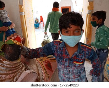 District Katni, Madhya Pradesh, India  - July 08, 2020: An Indian Boy Wearing Face Mask At Hindu Temple For Corona Virus Protection. 