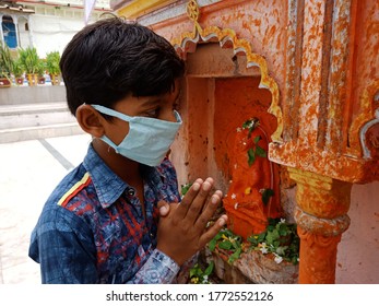 District Katni, Madhya Pradesh, India - July 08, 2020: An Indian Local Village Boy Wearing Facemask At Hindu Temple During Worship For Corona Virus Protection. 